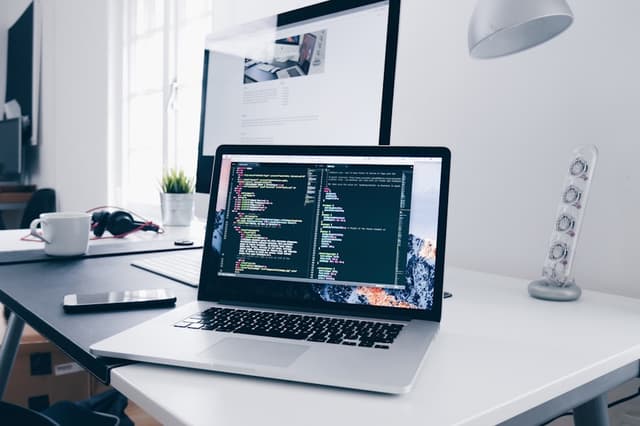 Laptop showing code on a desk